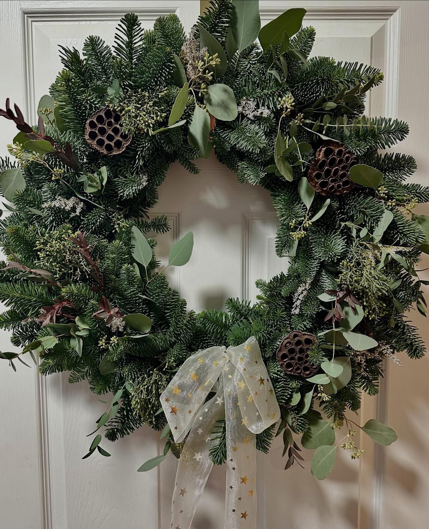 Seasonal Christmas floral arrangement by Willow and Moss