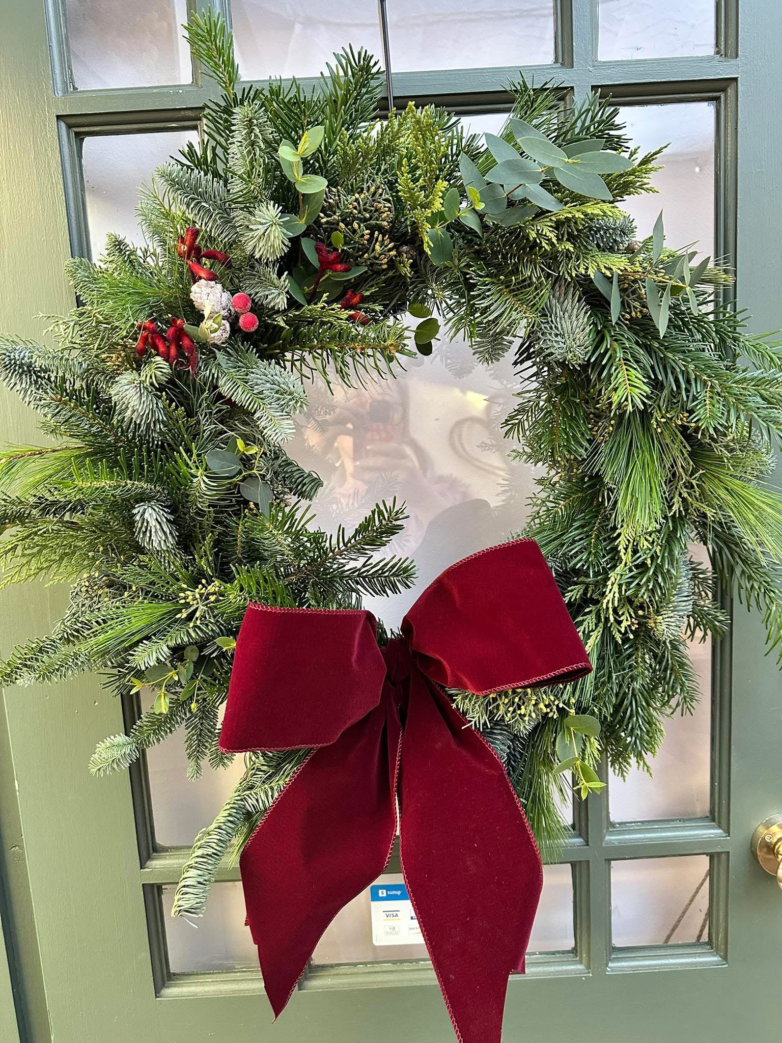 Seasonal Christmas floral arrangement by Willow and Moss