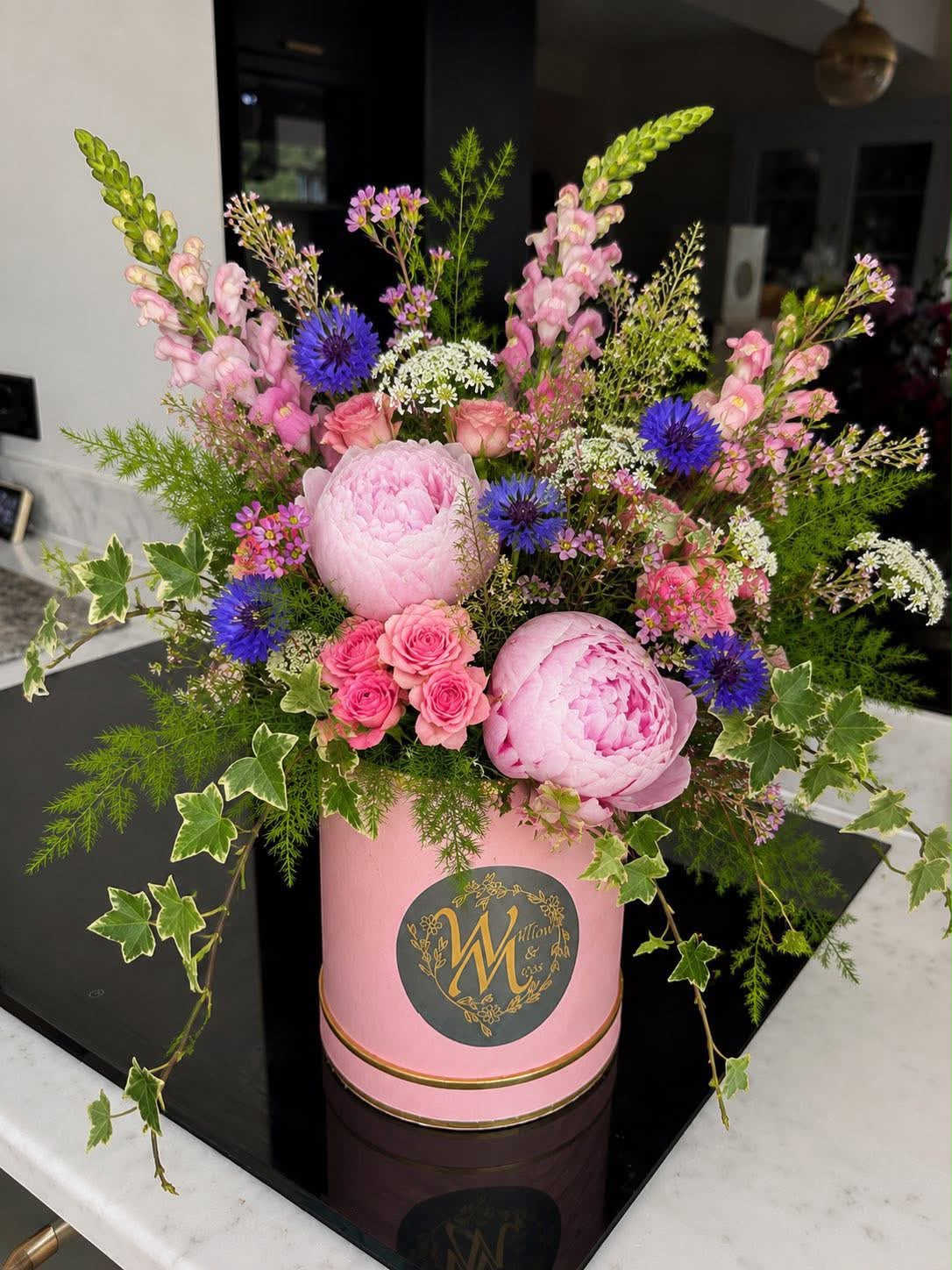 Hand-tied hat box of flowers by Willow and Moss