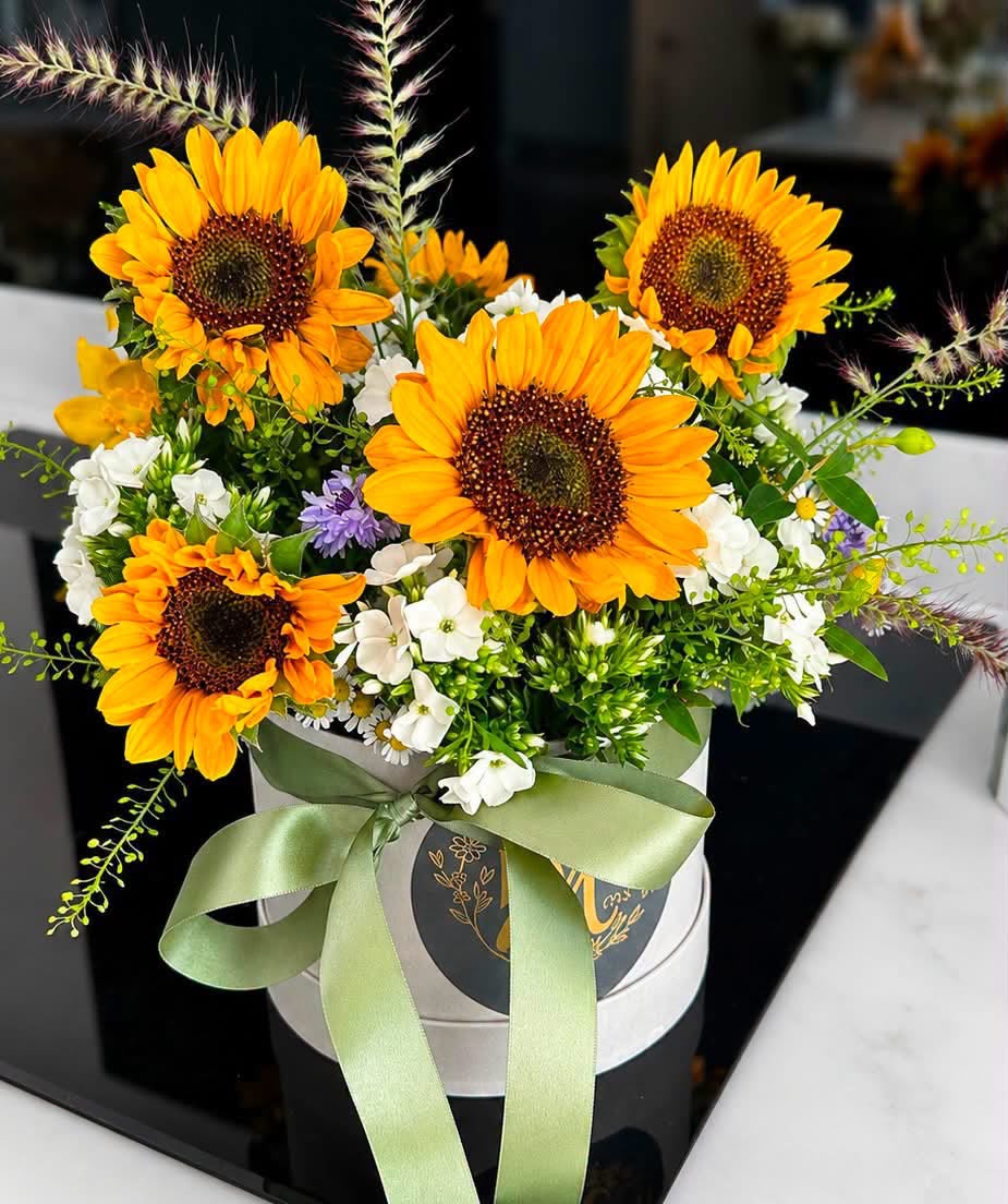 Hand-tied hat box of flowers by Willow and Moss