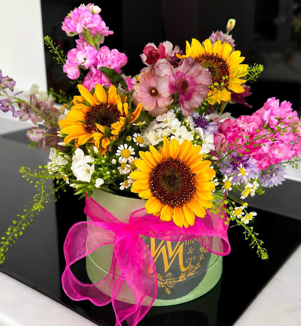 Flowers arranged in a hat box by Willow and Moss