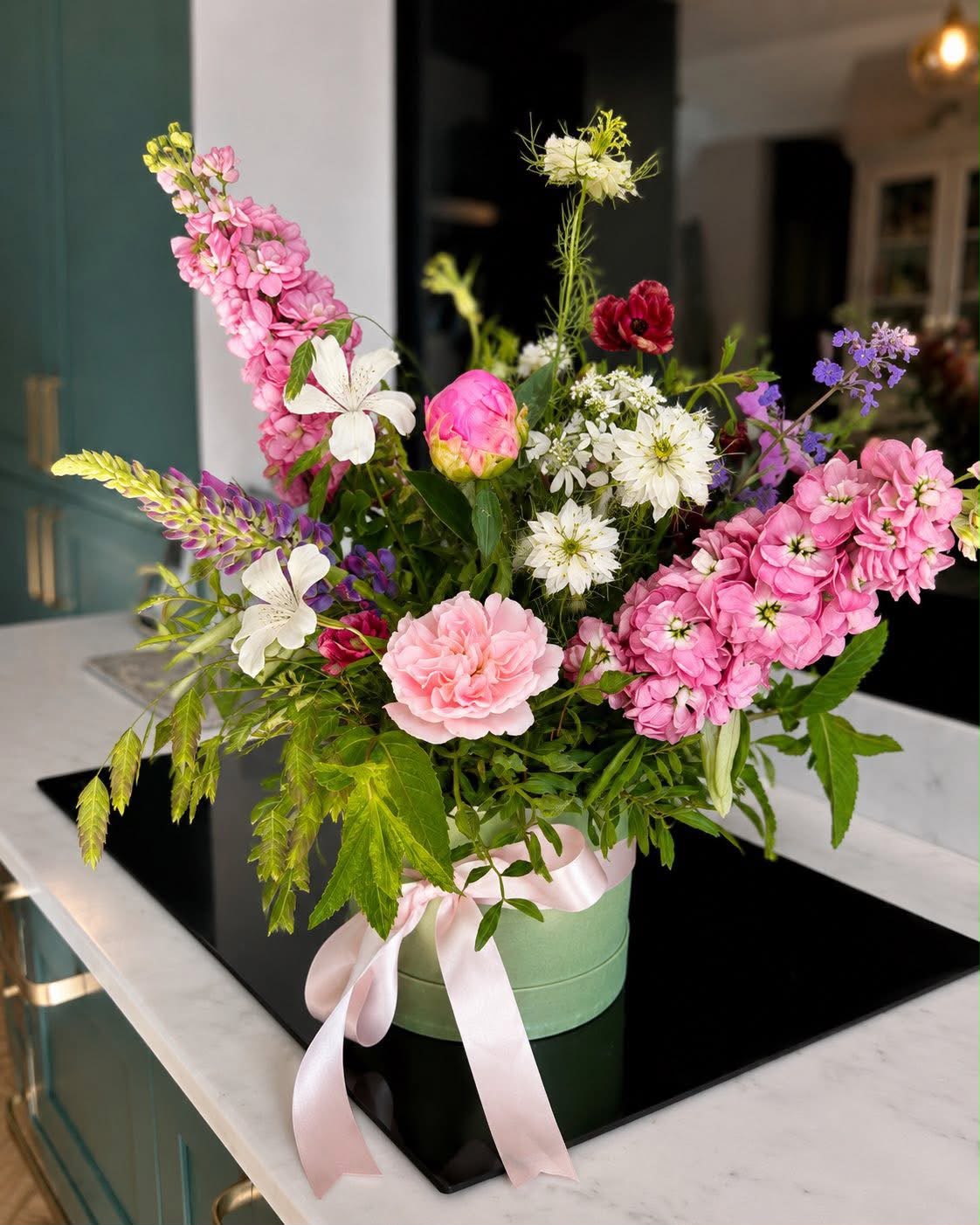 Hand-tied hat box of flowers by Willow and Moss