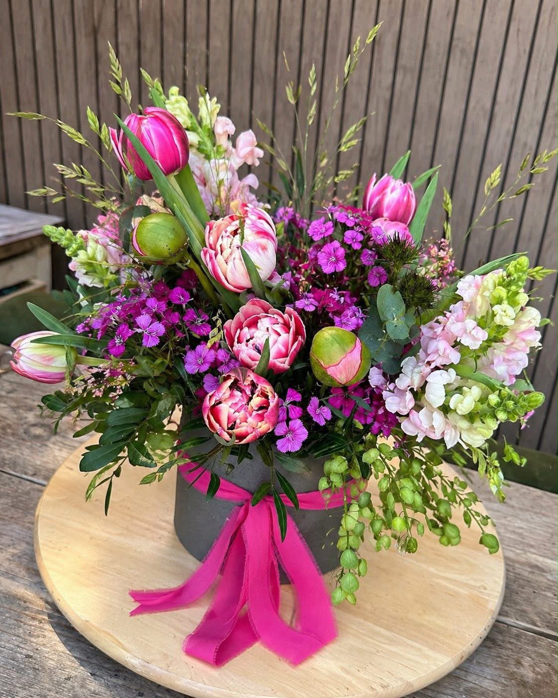 Flowers arranged in a hat box by Willow and Moss
