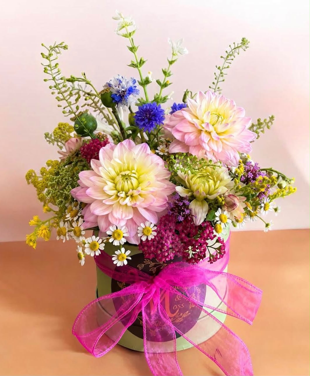 Flowers arranged in a hat box by Willow and Moss