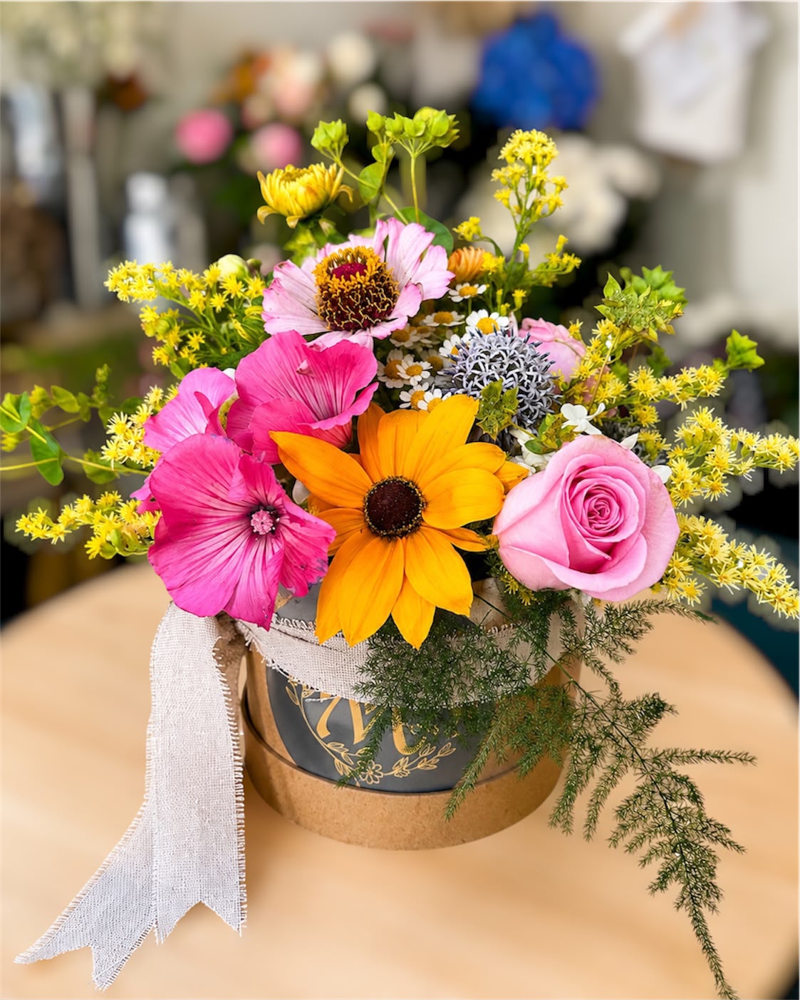 Flowers arranged in a hat box by Willow and Moss